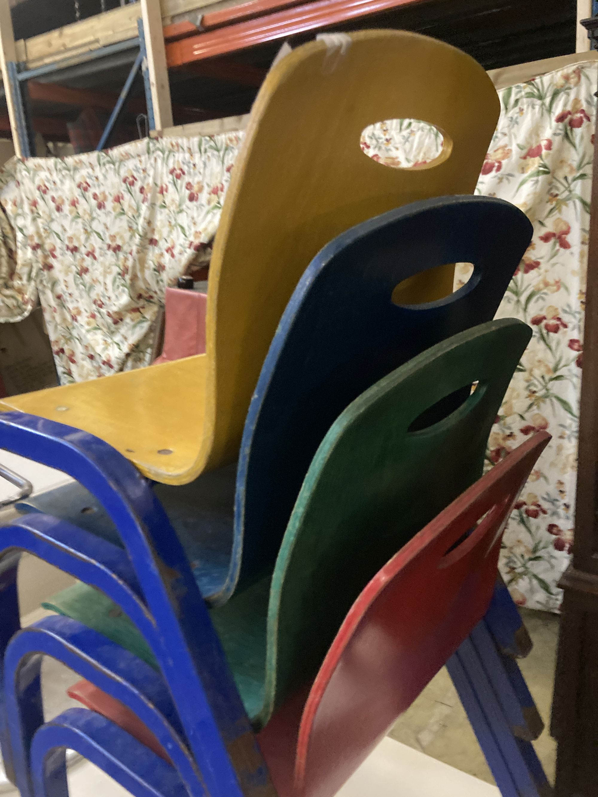 A set of four metal and ply childs stacking chairs
